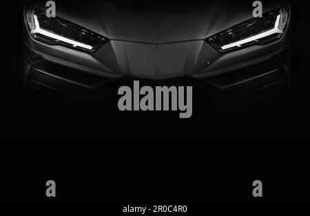 Close up detail front headlights of super car black and white background,copy space Stock Photo