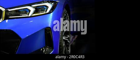 Front view of the LED headlights modern blue car on black background, copy space Stock Photo