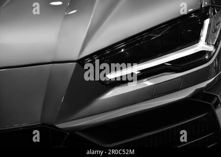 Close up detail front headlights of super car black and white background,copy space Stock Photo