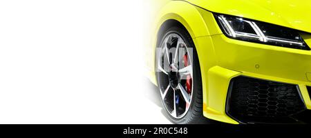 Front headlights of yellow modern car on white background,copy space Stock Photo