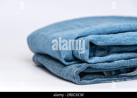 Stack of blue jeans on white background Stock Photo