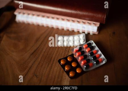 Monthly planner note book with medicine on table Stock Photo