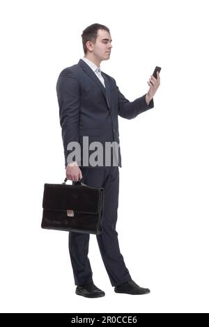 handsome young business man talking on a mobile phone and holding a suitcase on white background Stock Photo