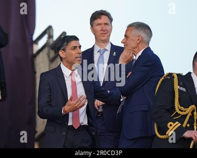 Prime Minister Rishi Sunak (left) in conversation with BBC director-general Tim Davie in the Royal Box, ahead of the Coronation Concert, held in the grounds of Windsor Castle, Berkshire, to celebrate the coronation of King Charles III and Queen Camilla. Picture date: Sunday May 7, 2023. Stock Photo