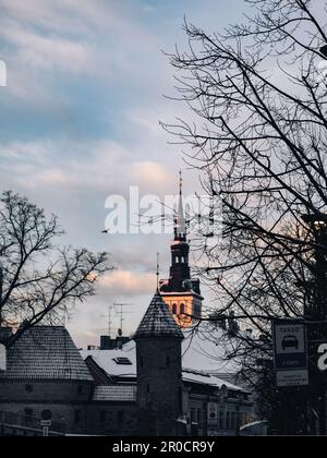 A stunning clock tower stands tall in the center of a charming town on a crisp winter day Stock Photo