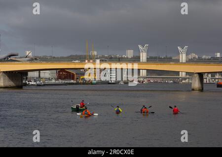 Kayakers on the Seine in Roue, France: the 20th century Guillaume le Conquérant bridge in front and the 21st century Gustave Flaubert bridge behind. Stock Photo