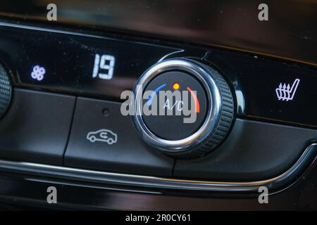Close up round air conditioner button and seat heating control inside car. Temperature digital display screen inside car. Stock Photo