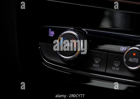 Close up dark menu button inside car panel. Selective focus. Stock Photo