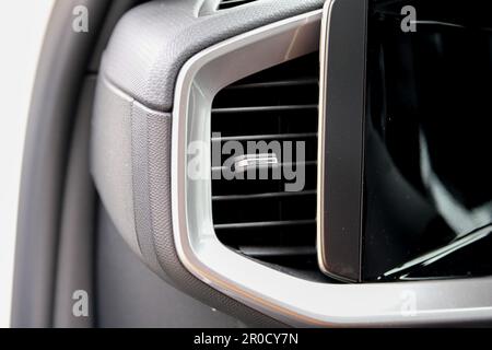 Close up modern heat vent inside car near car display screen. Stock Photo