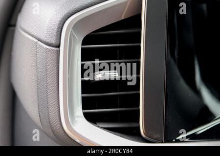 Close up modern heat vent inside car near car display screen. Stock Photo