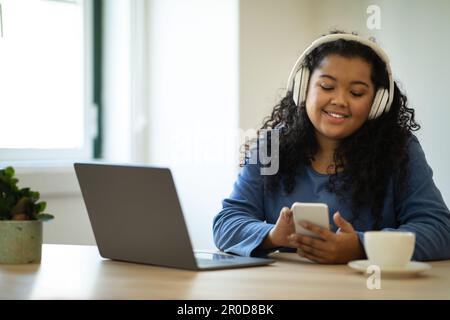 Happy young woman freelancer working from home, have break Stock Photo