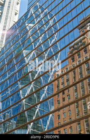 The diagrid glass Hearst Tower was built in 2006 atop the stone Hearst Magazine Building of 1928. Stock Photo