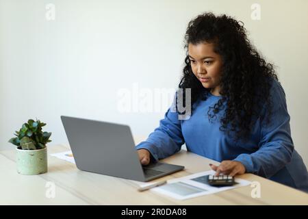 Chubby hispanic woman business analyst working from home office Stock Photo
