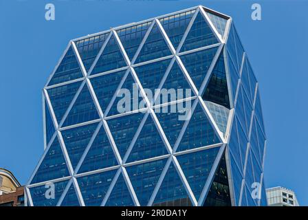 The diagrid glass Hearst Tower was built in 2006 atop the stone Hearst Magazine Building of 1928. Stock Photo