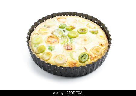 Quiche  with leek and cheese in baking form isolated on white Stock Photo