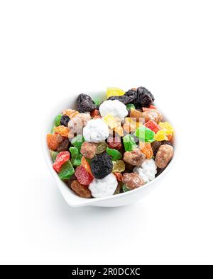 Sugar  coated nuts and candied fruit in white plate isolated on white background Stock Photo