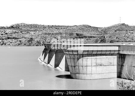 The Vanderkloof Dam overflowing. It is the second largest dam in South Africa. It has the tallest dam wall in South Africa. Monochrome Stock Photo