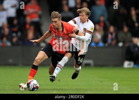 Luton Town's Reece Burke (left) and Hull City's Harry Vaughan battle for the ball during the Sky Bet Championship match at Kenilworth Road, Luton. Picture date: Monday May 8, 2023. Stock Photo