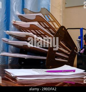 Plastic organizer for documents on the office desk. The pink pen lies on business papers, documents Stock Photo