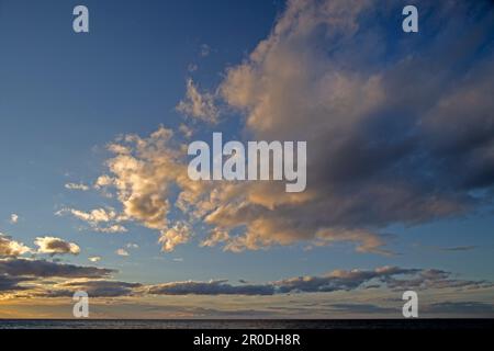 Sky scene over sea at sunset Stock Photo