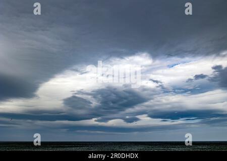 Sky scene over sea at sunset Stock Photo