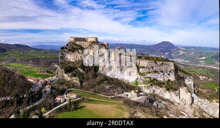 Unique beautiful places of Italy. Emilia Romagna region. Aerial drone view of impressive San Leo medieval castle located in the top of sandstone rock Stock Photo