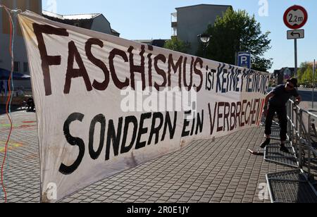 Demmin, Germany. 08th May, 2023. Participants gather for a demonstration against a NPD march, a banner reads 'Fascism is not an opinion but a crime!'. The occasion for the march of the right-wing extremists in the evening is a mass suicide in the city during the invasion of the Red Army between 30.04. and 03.05.1945. Credit: Bernd Wüstneck/dpa/Alamy Live News Stock Photo