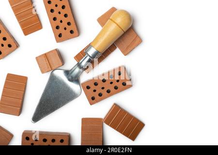 Mini ceramic bricks  and Trowel Building and construction equipment,  Construction  wall concept. Isolated on white Stock Photo
