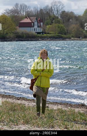Elderly woman at the beach, Northern coast, Holnis Peninsula, Schleswig-Holstein, Germany Stock Photo