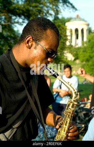 Saxophone player in English Garden at the Monopteros, Munich, Bavaria, Germany Stock Photo