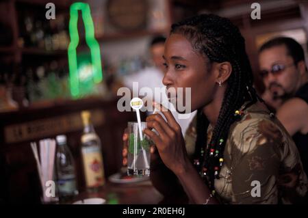 Young woman with drink at a bar, La Bodeguita del Medio, Havana, Cuba, Caribbean, America Stock Photo