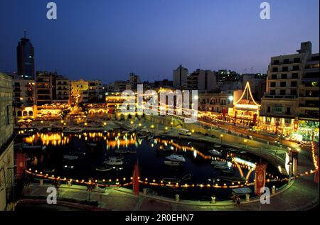 View of illuminated restaurants in the evening, Spinola Bay, Malta, Europe Stock Photo