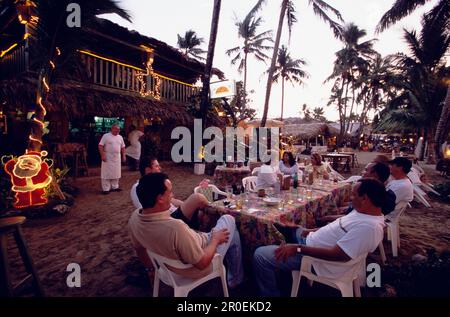 Restaurants, Evening Light, Beach, People, Evening light atmosphere in a restaurant, where people are sitting near the beach of Cabarete, Dominican Re Stock Photo