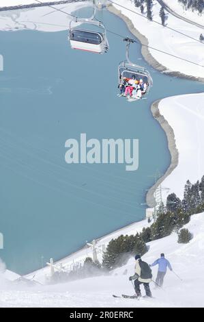 Skiers on slope and chair lift, reservoir in background, Kuhtai, Tyrol, Austria Stock Photo