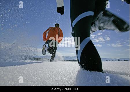 Young couple walking through powder snow Stock Photo
