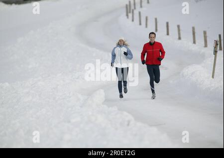 Young couple running on track Stock Photo