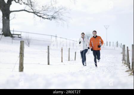 Young couple running on track Stock Photo