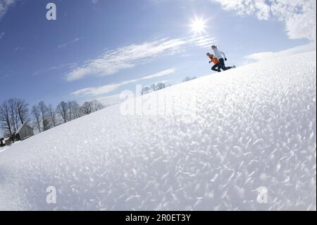 Young couple running through deep snow Stock Photo