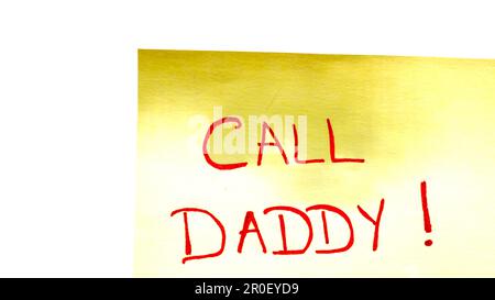 Call daddy handwriting text close up isolated on yellow paper with copy space. Stock Photo