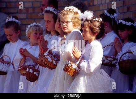 Young girls during the Procession on Flower Carpets for Corpus Christi in Spicimierz near Lodz, Poland Stock Photo