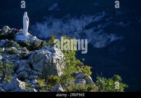 Madonna statue made from white marble on a cliff, Monte Colodri, Trentino, Italy Stock Photo