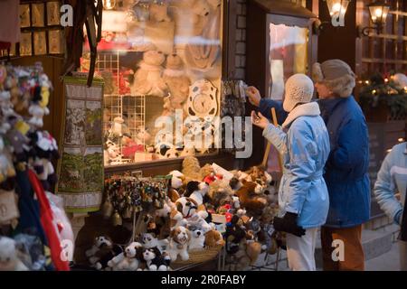 Couple choosing a souvenier in front of a souvenier shop at Bahnhofstrasse, Zermatt, Valais, Switzerland Stock Photo