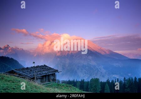 Traditional alpine hut in front of the Watzmann in the morning light, Berchtesgaden Range, Upper Bavaria, Bavaria, Germany Stock Photo