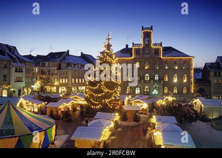 View over Christmas market to illuminated city hall, Weimar, Thuringia, Germany Stock Photo