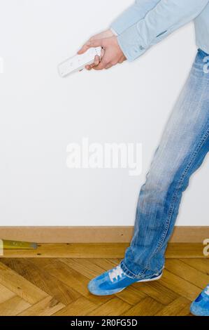 Person holding a remote control Stock Photo