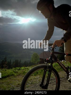Mountainnbiker over Simmen Valley, near Lenk, Bernese Alps, Canton Bern, Switzerland Stock Photo