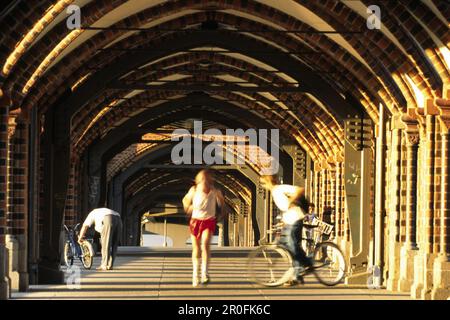 Man jogging over Oberbaum Bridge, Berlin, Germany Stock Photo