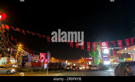 Cekmekoy, Istanbul, Turkey - 07.May.2023: night time view of a street with a lot of party flags hanging on a rope Stock Photo