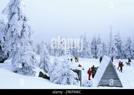 Tourists on snow covered Brocken summit, Schierke, Harz Mountains, Saxony-Anhalt, Germany Stock Photo