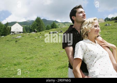 Young couple on alp, Heiligenblut, Hohe Tauern National Park, Carinthia, Austria Stock Photo